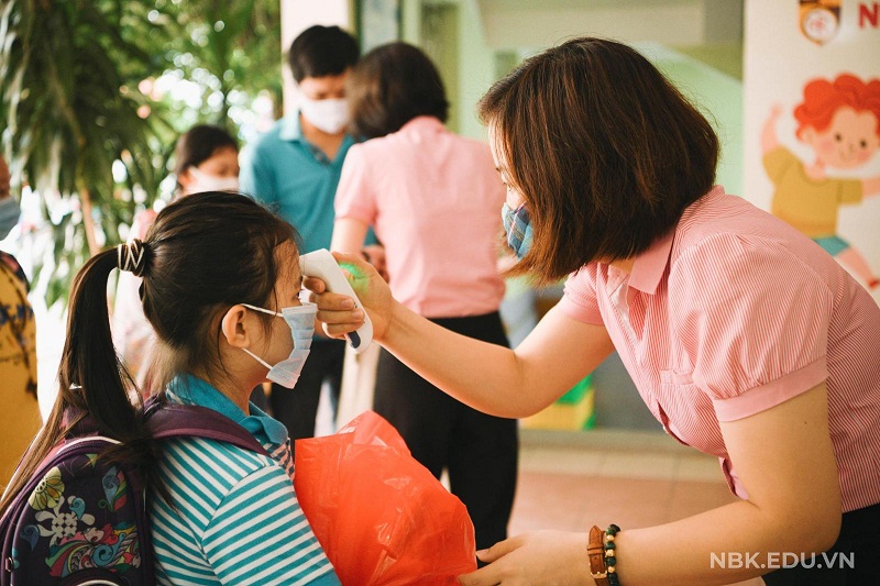 Năm học này, ngành GD-ĐT đặt mục tiêu vừa chống dịch Covid-19, vừa dạy tốt học tốt (ảnh: học sinh trường Nguyễn Bỉnh Khiêm được đo thân nhiệt trong ngày tựu trường)
