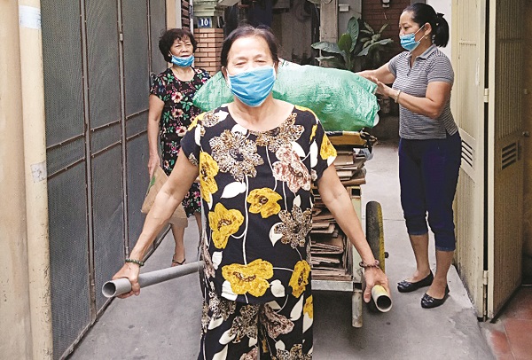 Chị em hội vi&ecirc;n phụ nữ phường Định C&ocirc;ng thu gom r&aacute;c t&aacute;i chế để g&acirc;y quỹ Hội