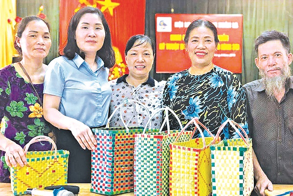 B&agrave; T&uacute;c (thứ hai từ phải sang) tại buổi khai giảng lớp tập huấn kỹ thuật đan l&agrave;n nhựa của Hội LHPN phường Xu&acirc;n La (T&acirc;y Hồ, H&agrave; Nội). Ảnh: Quỳnh An