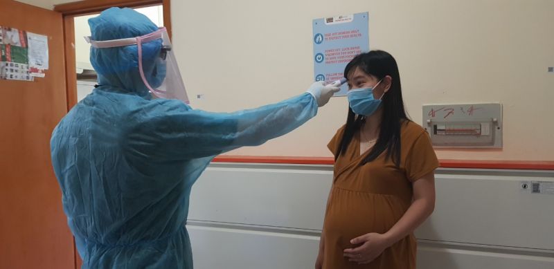 C&aacute;n bộ y tế đo th&acirc;n nhiệt mẹ bầu Đỗ Thị Giang