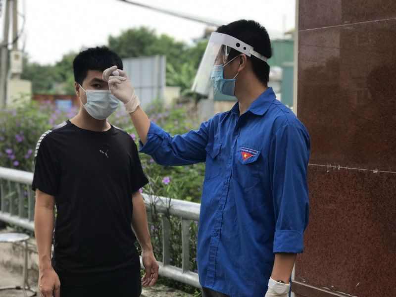 Các đoàn viên thanh niên hỗ trợ đo thân nhiệt tại các điểm trực chốt