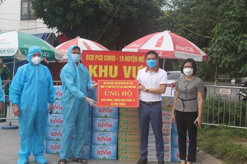 Đại diện lãnh đạo Hội LHPN huyện Mê Linh và nhà tài trợ tặng quà cho xã Tiến Thắng