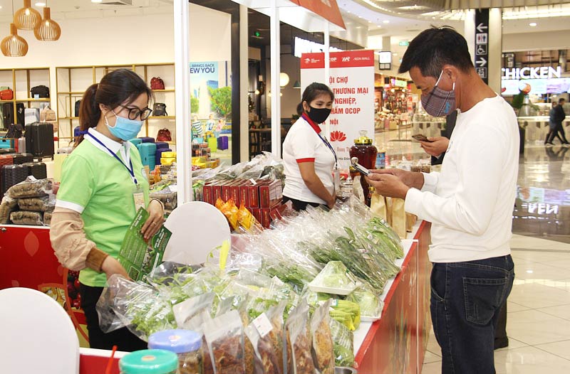 Khách chọn mua sản phẩm ở hội chợ xúc tiến thương mại nông nghiệp tại Trung tâm thương mại Aeon Mall (quận Hà Đông)