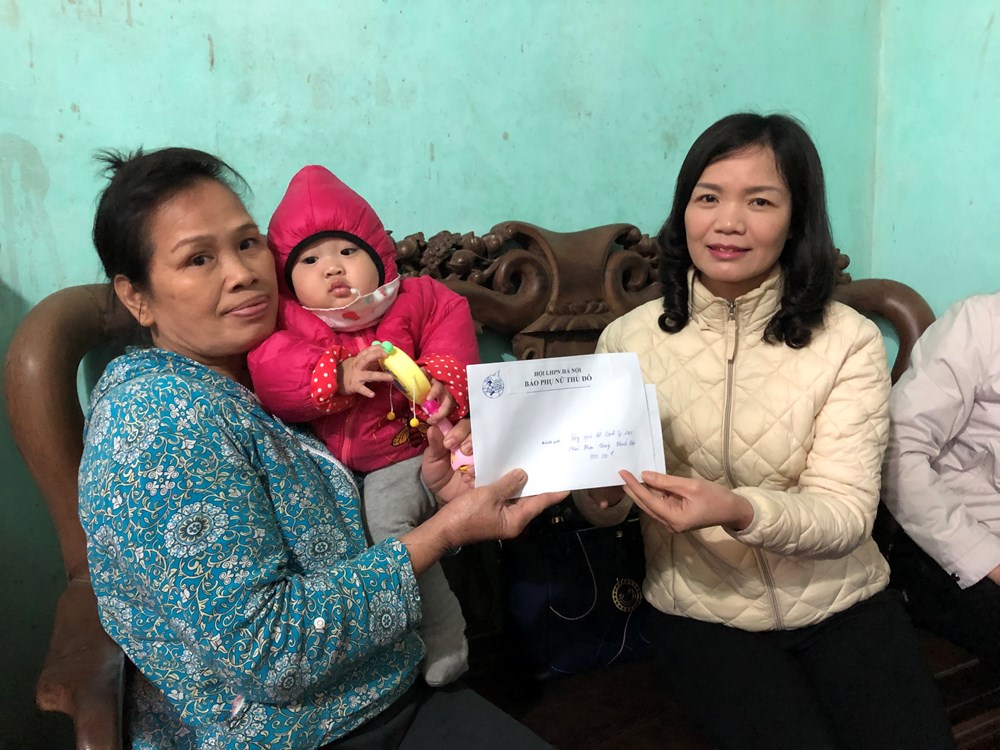 Chị Nguyễn Thị Bảy (bên phải) thay mặt đoàn đến thăm trao tặng số tiền 5 triệu đồng cho bà Nguyễn Thị Hiên (bà nội cháu Điệp)