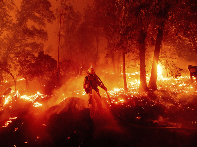 Lính cứu hỏa đang vật lộn với ngọn lửa khi nó đe dọa những ngôi nhà trong khu vực Cascadel Woods của Hạt Madera, California