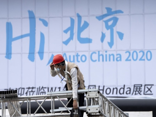 Một công nhân chuẩn làm việc ngày 24/9, để chuẩn bị cho triển lãm ôtô Bắc Kinh. Ảnh: AP.