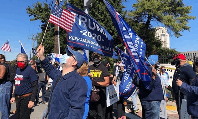 Người ủng hộ Trump cầm cờ, biểu ngữ bên ngoài Trung tâm Quân y Walter Reed ở ở Bethesda, Maryland, hôm 3/10. Ảnh: Breitbart News.