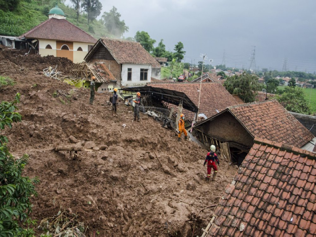 Lực lượng cứu hộ tìm kiếm các nạn nhân tại một ngôi làng bị ảnh hưởng bởi trận lở đất.