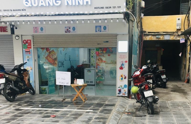 Cửa hàng đồ uống trên phố Lê Thanh Nghị bán hàng mang đi và bố trí nước sát khuẩn cho khách trước khi vào mua hàng