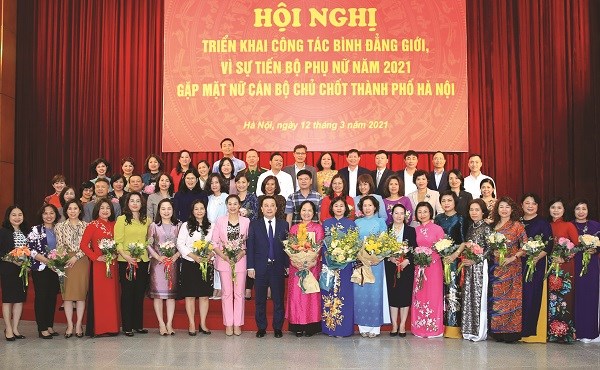 Đồng chí Chử Xuân Dũng - Phó Chủ tịch UBND thành phố Hà Nội, Trưởng Ban vì sự tiến bộ của phụ nữ thành phố tặng hoa các nữ cán bộ chủ chốt thành phố.
