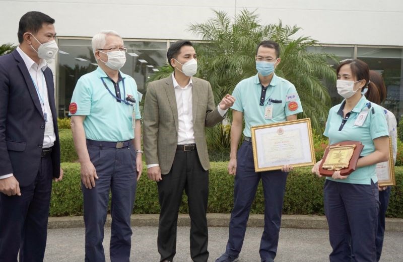 Phó Chủ tịch Liên đoàn Lao động TP Hà Nội Lê Đình Hùng trao khen thưởng và động viên công nhân giỏi, có sáng kiến kỹ thuật tại công ty TNHH Canon Việt Nam 	Ảnh: N.A